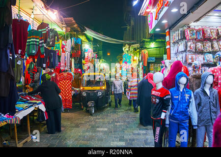 Kairo, Ägypten - Dezember 21, 2017: Der belebten engen Al Muizz Straße mit Kleidungsstück Stände, wandern Menschen und Fahren tuk tuks, am 21. Dezember in Kairo. Stockfoto