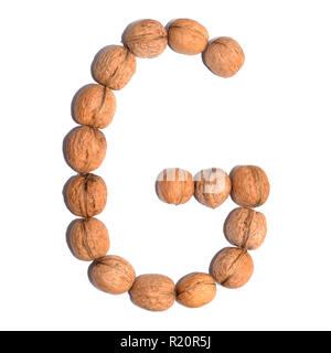 Buchstabe "G" mit Muttern einen Buchstaben des Alphabets zu bilden. Obst Buchstaben auf weißem Hintergrund. Stockfoto