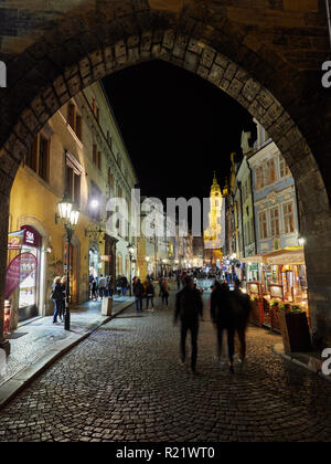 Prag, Tschechische Republik - 30. Oktober 2018 Menschen gehen durch die endgültige Arch von Saint Charles Brücke in Richtung Mostecka Straße der Kleinseite Stockfoto