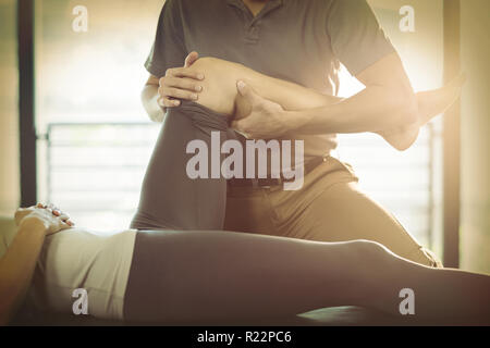 Physiotherapeuten, die eine Frau Knie Therapie geben Stockfoto