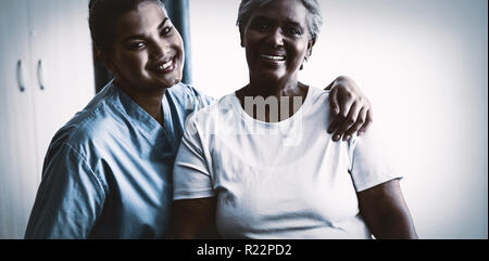 Porträt der jungen Krankenschwester mit Patienten im Pflegeheim Stockfoto
