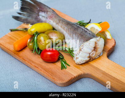 Kabeljau gebacken im rustikalen Stil. Rezept: besser zu nehmen cod Schwanz 250 gr, Reiben, mit Salz, Pfeffer. Backen im Backofen 20 Minuten bei 220Gr. Garniert mit gekochten potat Stockfoto