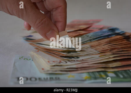 Konzept: Business und Finanzen. Hand und Haufen von Euro Stockfoto