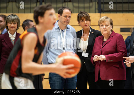 Chemnitz, Deutschland. 16 Nov, 2018. Die deutsche Bundeskanzlerin Angela Merkel (1. R) Uhren das Training der Basketball Club Niners Chemnitz bei ihrem Besuch in Chemnitz, Ostdeutschland, am 16. November, 2018. Angela Merkel am Freitag ihre Flüchtlingspolitik während ihres Besuchs in Chemnitz, ein Ort im Zentrum von mehreren schweren ausländerfeindlichen Proteste vor Monaten angesehen geklärt. Credit: Kevin Voigt/Xinhua/Alamy leben Nachrichten Stockfoto