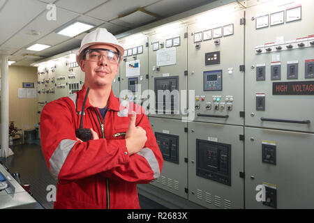 Das Schiff ist Mechaniker in der Nähe der Marine Diesel Generatoren auf ein Handelsschiff in den Maschinenraum mit alle Rohrleitungen, Generatoren, turbins, etc. Etwas schreiben d Stockfoto