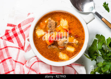 Gulaschsuppe am weißen Stein Tabelle Ansicht von oben. Stockfoto