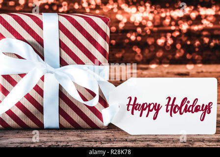 Ein Weihnachtsgeschenk, Kalligraphie Happy Holidays, Bokeh Stockfoto