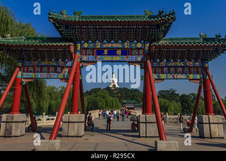 Peking, China - September 20, 2013: Menschen auf Yongan Brücke im Beihai Park mit der Jade Island, Bai Ta (weiße Pagode oder Dagoba) stupa und Buddhistischen Y Stockfoto