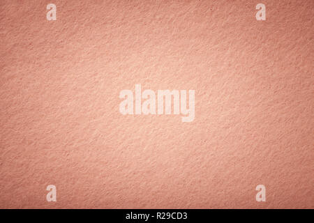 Rose Gold matt Hintergrund von Velours Stoff, Nahaufnahme. Samtene Textur von nahtlosen Coral Wollfilz mit Vignette. Stockfoto
