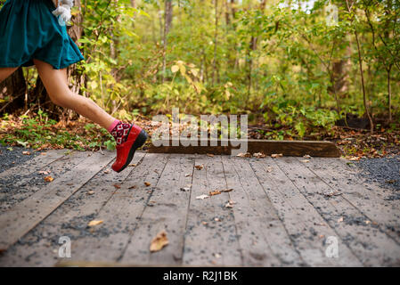 Mädchen über eine kleine Fußgängerbrücke laufen, United States Stockfoto