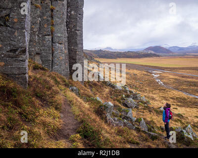 Touristische stehendes Mädchen in der Nähe von Gerduberg Basaltsäulen, Island und zuzusehen, wie sie Stockfoto