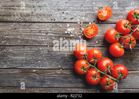 Frische Trauben Tomaten mit grobem Salz, Ansicht von oben mit der Kopie Raum Stockfoto