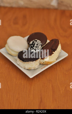 Frische und köstliche kleine Mix eclairs, cremige Kuchen Stockfoto