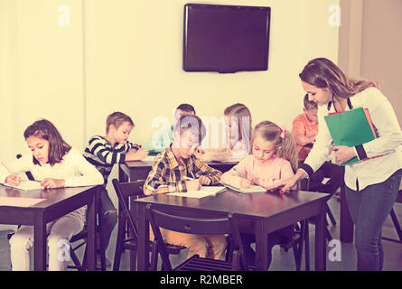 Professor und elementare Alter Kinder in einem Klassenzimmer in der Schule Stockfoto