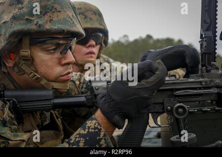Us Marine Corps Lance Cpl. Charles L. Stewart, Links, mit Bekämpfung Logistik Bataillon 6, 2 Marine Logistics Group, inspiziert ein M240B Maschinengewehr für Hindernisse bei einem Schießplatz in Camp Lejeune, N.C., Nov. 2, 2018. Marines feuerten auf der Strecke, um ihre Fertigkeiten im Umgang mit M240B Maschinengewehr zu erhöhen und gleichzeitig ihre Fähigkeit, in kürzester Zeit zu implementieren. Stockfoto