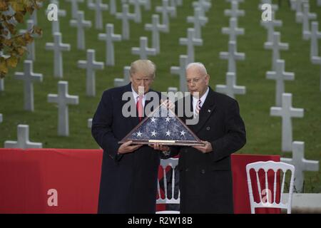 Präsident Donald J. Trumpf präsentiert eine amerikanische Flagge, Sekretär der American Battle Monuments Kommission, pensionierte Generalmajor William M. Matz, Suresnes amerikanischen Friedhof beim Ehren das hundertjährige Der Armistice Day, Paris, Frankreich, November 11, 2018. Die Zeremonie wurde auf das 100-jährige Jubiläum des Waffenstillstandes, der sich auf dem elften Stunde gehalten, der elfte Tag des elften Monats des Jahres 1918, markiert das Ende des Ersten Weltkriegs. Stockfoto