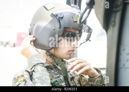 Spc. Jon Baldwin, ein UH-60 Blackhawk Hubschrauber Repairer, in den zweiten Angriff Hubschrauber Bataillon zugeordnet, 82nd Combat Aviation Brigade, in Partnerschaft mit 3 Combat Aviation Brigade sichert seinen Helm vor dem Flug das Ministerium für Heimatschutz und Zoll und Grenzschutz Beamten während der Boarder zu unterstützen, November 8, 2018. Us Northern Command ist die militärische Unterstützung für das Ministerium für Heimatschutz und den US-amerikanischen Zoll- und Grenzschutzbehörden der südlichen Grenze der Vereinigten Staaten zu sichern. ( Stockfoto