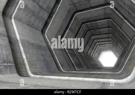 Der Blick in eine konkrete Tunnel aus Sechseckigen geometrische Formen mit einem Licht in der Ferne, am Ende - 3D-Rendering Stockfoto