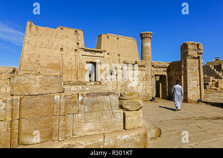 Eine Arabische Menschen auf dem Weg zu den Eingang des Tempels von Edfu, einem ägyptischen Tempel entfernt auf dem Nil in Edfu, Ägypten, Nordafrika Stockfoto