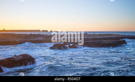 Sunset Bay State Park lebt bis zu seinem Namen wie die untergehende Sonne wirft einen sanften Lichtschein über Ebbe. Stockfoto