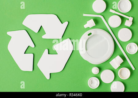 Ansicht von oben Bereiten Sie Zeichen und verschiedene Arten von Einwegflaschen aus Plastik Müll auf grünem Hintergrund Stockfoto