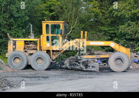 Ein Caterpillar grader Maschine bis auf den alten Recycoal Kohle Recyclinganlage geparkt auf Rossington, Doncaster, South Yorkshire, der jetzt abgerissen wurde. Stockfoto