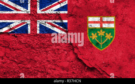 Flagge Ontario schließen bis auf einen Riss in der Wand, Konzept der bewaffneten Aktionen und Konflikte in der Welt lackiert Stockfoto