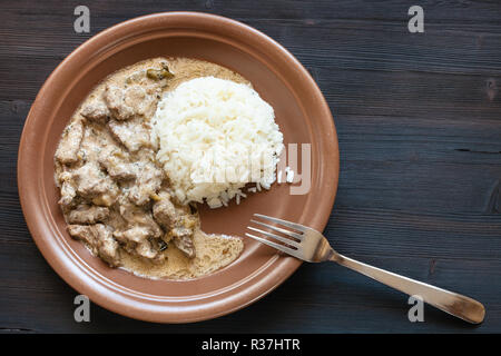 Russische Küche Teller - für das Essen ein Teil von Rindfleisch Stroganoff (Beef Stroganov, Befstroganov) Stück Fleischeintopf in der sauren Sahne mit gekochten vorbereitet Stockfoto