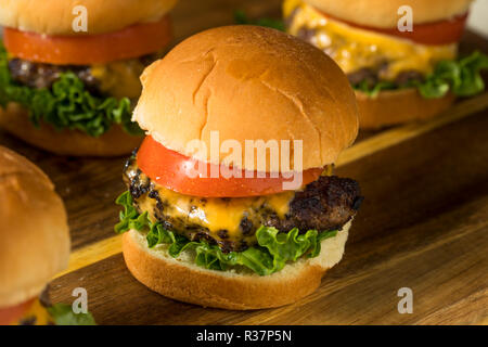 Selbstgemachte Cheeseburger Schieberegler mit Tomate und Salat Stockfoto