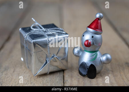Weihnachtsschmuck auf dem Küchentisch. Holz- Weihnachten figuren vorbereitet für die Verzierung eines Baumes. Der dunkle Hintergrund. Stockfoto