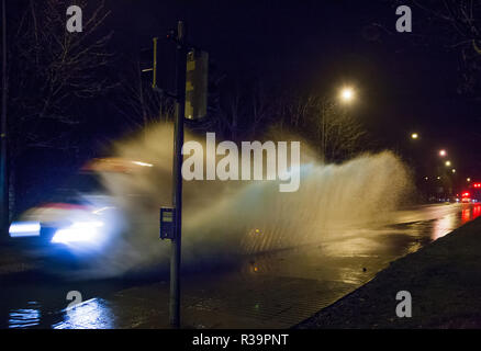 Carrigaline, Cork, Irland. 23. November 2018. Am frühen Morgen den Verkehr durch einen Abschnitt der überfluteten Straße nach einer Nacht des schweren Regens an bothar Guidel, Carrigaline, Co.Cork. Stockfoto