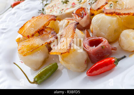 Topinambur gratiniert mit Schinken und Chili Stockfoto