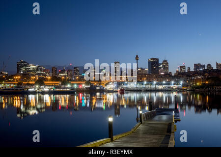 Glebe Ruderer Club Jetty und Sydneys Blackwattle Bucht mit Fischmarkt über die Bucht in der Dämmerung Stockfoto