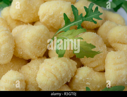 Roh ungekocht Gnocchi mit Rucola Salat Stockfoto