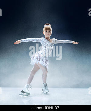 Kleines Mädchen Eiskunstlauf im Hallenbad Ice Arena. Der Tanz, Sport, Winter, Übung, Training, Kindheit, Meister Konzept Stockfoto