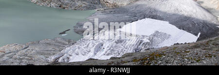 Klima Rhone: Riesige Fleecedecken bedecken Teile des Rhonegletschers in der Schweiz, um das unvermeidliche Schmelzen von Schnee und Eis zu vereizen. Nach einem Winter mit Rekordschneemengen war der größte Teil davon verschwunden, als dieses Bild am 14. Juli 2018 aufgenommen wurde, das das dunklere Eis freilegt. Während Schnee ein brillanter Reflektor der Sonnenenergie ist, absorbiert das dunklere Eis stattdessen die Energie und beschleunigt so das Schmelzen des Gletschers. Die Farbe und Dunkelheit des Gletschereises variiert weltweit, je nach Verschmutzungsbildung, Alter des Eises, vom Eis und vom Mikro aufgepflückten Partikeln Stockfoto