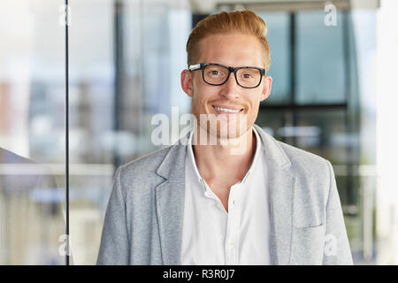 Portrait von lächelnden redheaded Geschäftsmann mit Brille Stockfoto