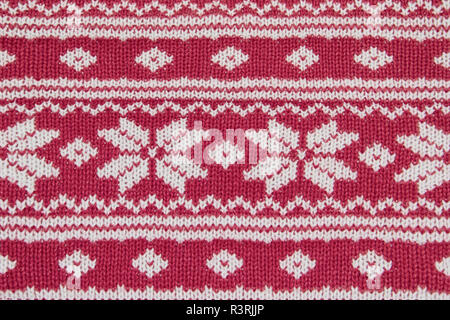 Gestrickt, es ist rot, einen weißen Hintergrund Textur aus Stoff Ornament ist ein Neues Jahr Stockfoto