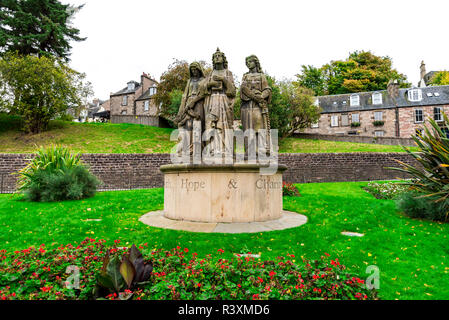 Eine Skulptur, die Zusammensetzung der 3 heiligen: Glaube, Hoffnung und Liebe in einem kleinen Garten vor der Ness Bank Kirche, Inverness, Schottland Stockfoto