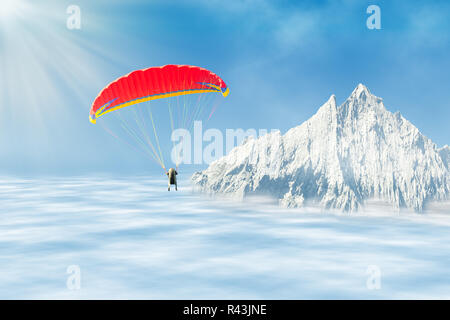 Freestyle Solo Paragliding über Wolken gegen Berg Stockfoto