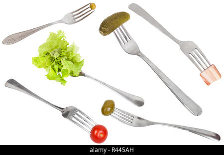 Einstellen der Gabeln mit aufgespießt Lebensmitteln isoliert Stockfoto