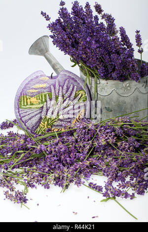 Gießkanne, Kerze und Lavendel isoliert auf weiss Stockfoto