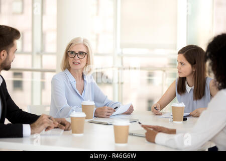 Schwere reifen Executive bei Office Briefing an Mitarbeiter Stockfoto