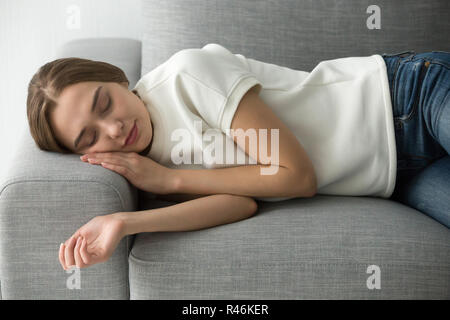 Attraktive Frau schlafen auf komfortables, weiches Sofa Stockfoto