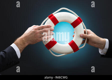Unternehmer, die rettungsring Über blauer Hintergrund Stockfoto