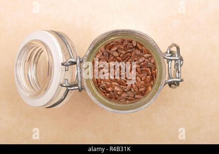 In Glas auf braunem Hintergrund Leinsamen Stockfoto
