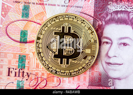 Bitcoin mit einem Stapel von 50 Pfund Sterling bank Notes Stockfoto