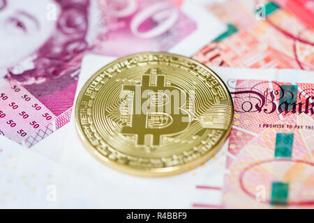 Bitcoin mit einem Stapel von 50 Pfund Sterling bank Notes Stockfoto