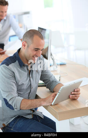 Junge lächelnde Mann in der Ausbildung Klasse mit digitalen Tablet Stockfoto
