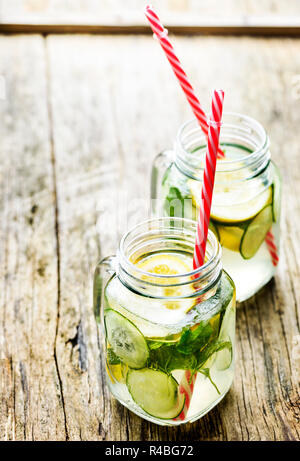 Gesunde Ernährung lifestyle Konzept. Detox Limonade mit Gurke und Minze in retro Mason jar Glas auf Holztisch mit Copyspace. Stockfoto